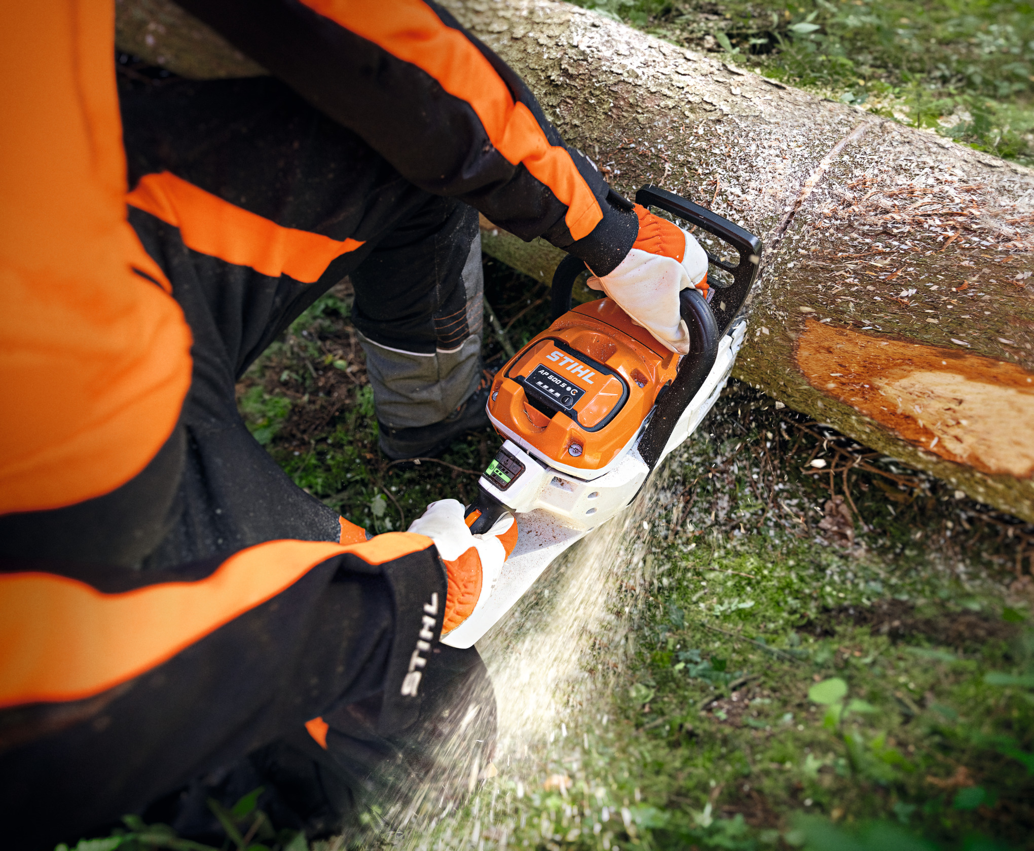 A man cutting log with a chainsaw